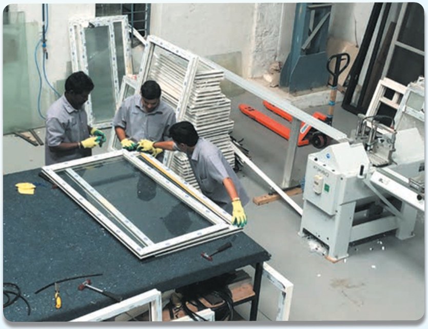 Technicians assembling a uPVC window frame at the InGlaze factory